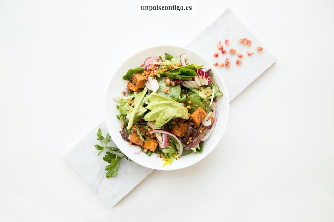 cooked food with sliced vegetables in white bowl