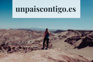 woman on black dress atop of canyon looking at the mountainous terrain during daytime