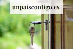 Key inserted in door lock against a blurred green background, symbolizing security and real estate.