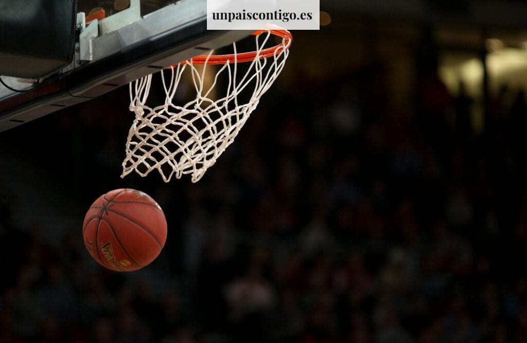 A basketball going through the hoop during a fast-paced game, capturing the excitement of the sport.
