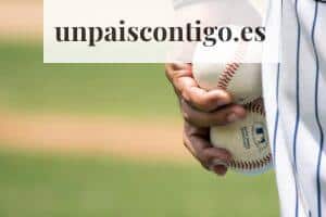person holding two baseballs