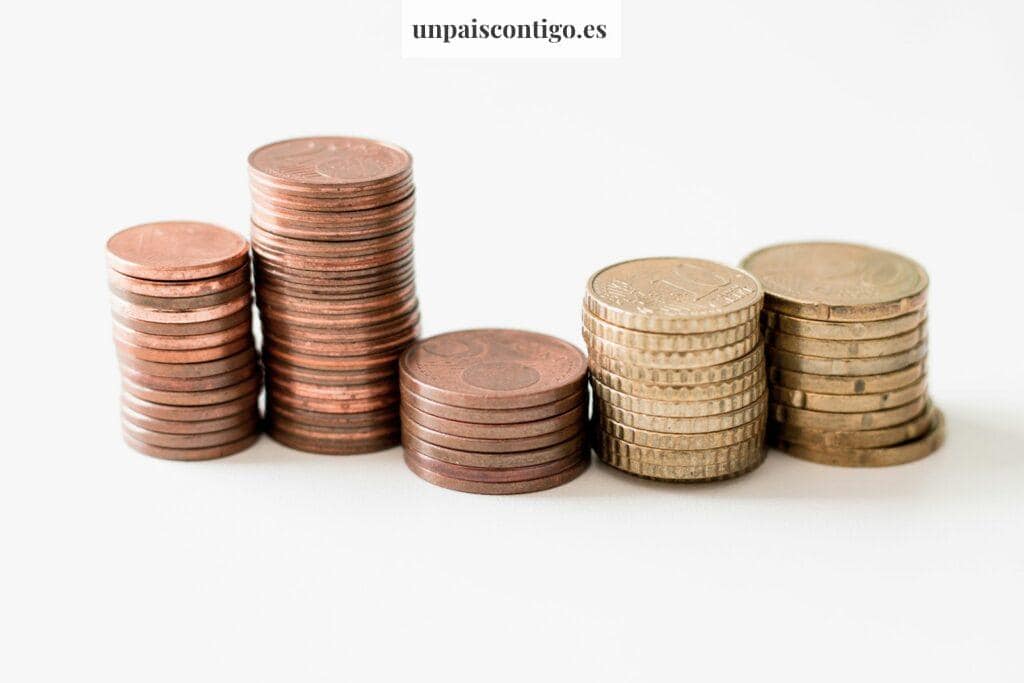 stacked round gold-colored coins on white surface