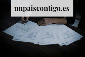 a woman sitting at a table with lots of papers