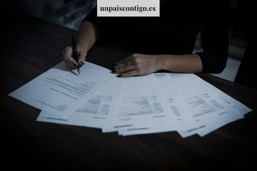 a woman sitting at a table with lots of papers