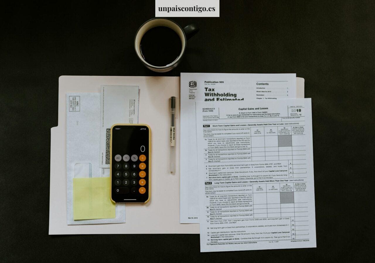 black Android smartphone near ballpoint pen, tax withholding certificate on top of white folder