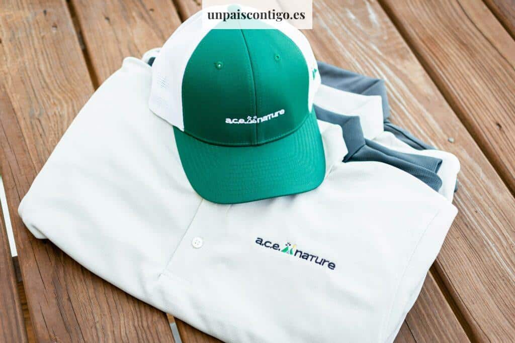 a green and white hat sitting on top of a white shirt